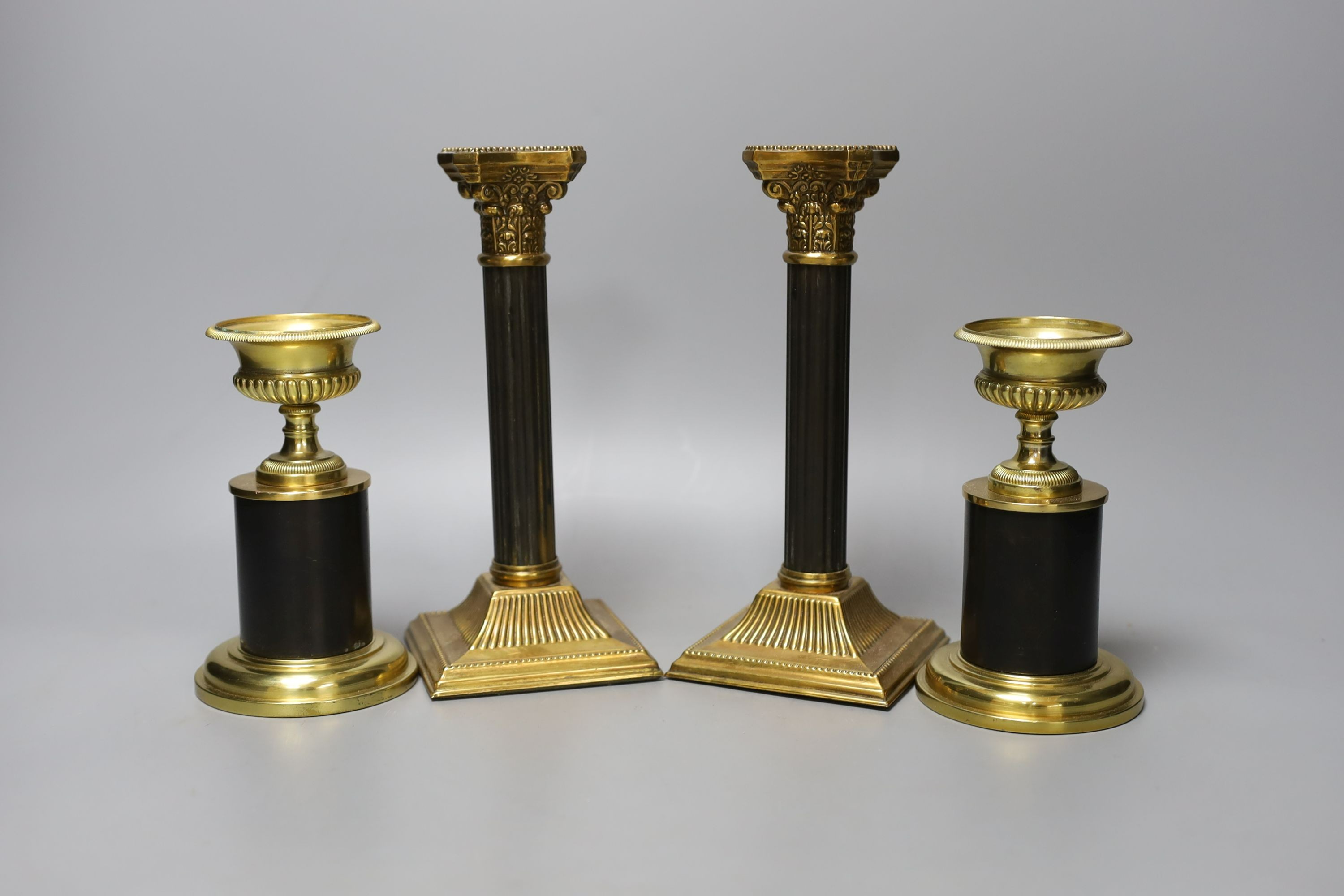 Two pairs of two-colour bronze or brass candlesticks, tallest 21cm